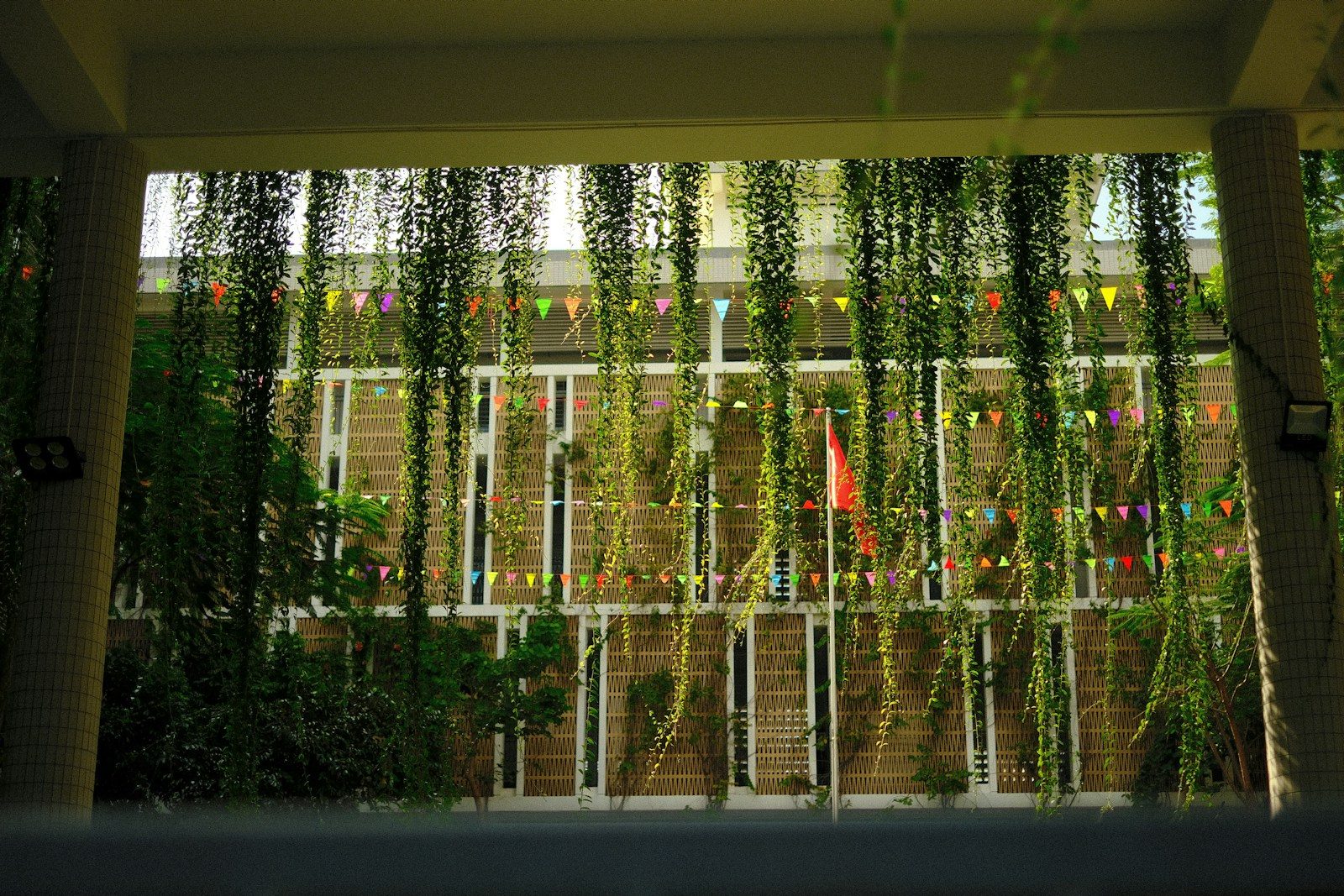 Building facade with hanging plants and bunting